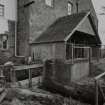 General view from SW of water wheel house, showing sluices controlling water flow to wheel house and to by-pass lade.