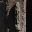 Detail of carved figure to left of doorway on W side of tower.