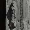 Detail of carved figure to right of doorway on W side of tower.