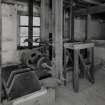 Interior. first floor of mill, view from NW of belt-pulley arrangement linked to gear-cupboard (on ground floor below), towards S end of the mill