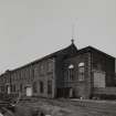 General view from E of S elevation of works, with former engine house at E end of range.