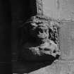 Detail of corbel on hoodmould above main entrance.