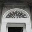 Detail of main doorway showing upper shafts of pilasters, entablature and fanlight.