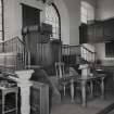 Interior.
View from NE showing font, pulpit, communion table, collection paddles and salvers.