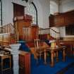 Interior.
View from NE showing font, pulpit, communion table, collection paddles and salvers.