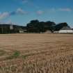 Distant view from S showing church and school.