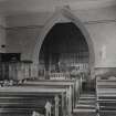 Interior.
Detail of c.1910 photograph showing re-ordered church with new pulpit, chancel panelled using original pews, medieval font and new chancel fittings.