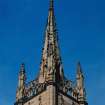 View of spire with wallhead parapet and pinnacles.