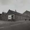 Exterior view from SSW of single-storeyed weaving sheds on corner of Arbroath Road and Morgan Street