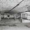 Dock Street building. Interior.
General view of brick vaulting at West end of basement, cast-iron columns 0.18m dia, bottom flanges of the cast-iron beams they support 0.21m wide. The vaulting is 0.38m deep, and columns are at 3.3m centres. Flagstone floor.