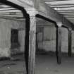 Exchange Street Building. Interior.
General view of second floor, West half of block, showing typical flanged columns for slotted partitions. Columns are 0.12m dia at 3.25m centres, having cast-iron saddles on top for wooden beams.