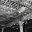 Detail beneath yard of cast-iron column (0.22m dia) and 'I' section beam (300mm deep by 170mm along bottom flange) supporting smaller 'I' section iron cross beams between which hollow fireclay ceiling tiles are slotted.