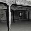 Dock Street Building. Interior.
General view of second floor with typical cast-iron columns with vertical flanges for slotting in partitions. Columns are in two rows at 3.4 - 3.7m centres, and are 0.12m dia at the top. Cast-iron saddles carry wooden beams 330mm deep, 250mm wide.