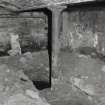 Exchange Street Building. Interior.
Detail of column in West half of basement. Cast-iron columns are 0.18m dia and 1.85m high at 3.3m centres, cast-iron beams bottom flange is 0.2m wide. Depth of arch is 0.38m. Flagstone floor.