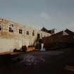East half of Mill and (Right) single storeyed brick extension, with gable of warehouse to rear viewed from South-West.