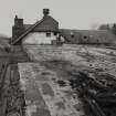 View along top floor of the Mill from East showing chimney and boiler house (Left). Note the cast-iron frame of Mill at wallhead. The roof and double attic of the Mill have been destroyed by a fire.