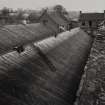 General view from West on top floor of Mill, showing (L-R) Weaving Room roof, Mechanic's Chop and Office. The roof and double attic of the Mill have been destroyed by fire.