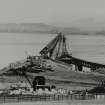 Two negatives and two black and white prints (duplicates). 
The second railway bridge; view from South ie Fife towards Dundee.  Also visible is the first Tay Raiwlay Bridge in the process of dismantling.