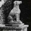 Detail of statue of dog at foot of stone stair (no.2 on plan), from West.