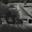 View looking W from water tower to indoor games, lecture room, contractors ablutions/store and contractors office. (huts 14-15, 106-108)