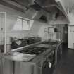 Interior view of sergeants mess, showing kitchen ranges and equipment