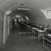 Interior view of R & F accommodation hut (hut 80) showing  line of beds with lockers