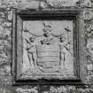 Detail of armorial panel above entrance to courtyard.