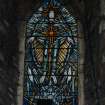 Interior. Detail of W gable stained glass window of the Ascending Christ