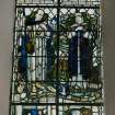 Interior. Detail of chancel stained glass window depicting SS Euan and Bride " That in the name of Jesus every knee shall bow"