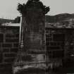 General view of grave 140, commemorating Maegaret McFarlane. Large gravestone with urn and curved broken pediment. Hand holding scroll with inscription and double torches.