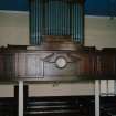 Interior. Detail of organ, clock, gallery front and columns