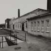 View from NNW of workshop buildings and Boiler House (with fuel oil tanks) and chimney stack
Photographed 27 January 1994