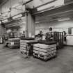 Empty Bottle Store: View from NW start of bottling line No. 10, showing cartons of bottles being unpacked and loaded onto conveyors.
Photographed 27 January 1994