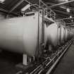 Bulk Storage: View of row of ten glass-lined steel vats, which act as receivers for whisky tankered in by road from distilleries.
Photographed 27 January 1994