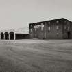 View from W of (R to L) Material Store, and vaulted canopy at NW frontage of Empty Bottle Store, adjacent to Bottling Store.
Photographed 27 January 1994