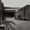 General view from SE showing tanker bay at which road tankers unload whisky into the bulk storage tanks (in building to left, adjacent to Blending Department in the South Bonded Stores).  Other buildings to the right include the Materials Stores and Bottling Hall.
Photographed 27 January 1994