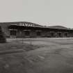 General view from N of Cased Goods Warehouse, showing external canopy and loading platform.  The building has a steel frame, with extrenal walls of light brown facing brick, the base coursesbeing of blue engineering brick
Photographed 27 January 1994