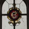 Orchil House, interior.
Detail of staircase hall stained glass window with EJC monogram.