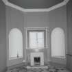 Interior. Ground floor S octagonal entrance hall showing fireplace beneath the window and flanking niches