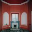 Interior. Ground floor S octagonal entrance hall showing fireplace beneath the window and flanking niches