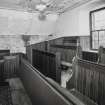 Interior, E gallery, pews, view from SSW