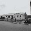 View of WW11 building to right of security gate from WSW.