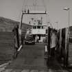 View from WSW of ramp and Isle of Rhum ferry moored at the Scalpay side, prior to moving into position to receive cars and foot passengers