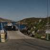 View from WSW of ramp and Isle of Rhum ferry moored at the Scalpay side, prior to moving into position to receive cars and foot passengers