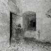 Interior, tower, third floor, South wing, vaulted chamber, view of South West window (set into arched opening) next to fireplace.