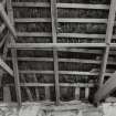 Interior: Thatched house, view of underside of roof showing purlins and rope rafters