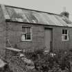 Corrugated-roofed building to SW of farmhouse, view from SE