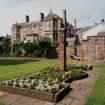 Main house, flower bed and pillar, view from South East.