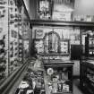 View of interior of tobacconists shop from S showing display cases containing pipes and cigar boxes