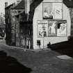 Edinburgh, 8-10 Gloucester Street.
View down the street, with the end wall of the houses covered in posters, including 'Ovaltine', 'Unzipp a banana', 'Cluny', 'McEwans'.